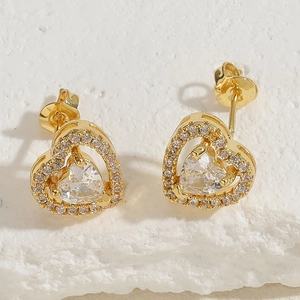Macro shot of 14K gold plated heart stud earrings with sparkling cubic zirconia inlay