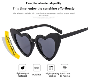 Detail view of heart-shaped oversized sunglasses with wide black frame and durable lenses