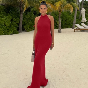Close-up of red knitted halter neck maxi dress with backless design and ruffle details