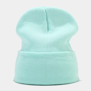 Detail shot of the fine knit texture and folded cuff on this mint green winter beanie