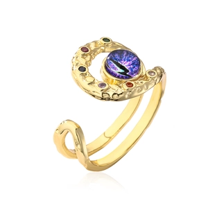 Detailed view of bohemian gold evil eye ring with purple stone and hammer texture