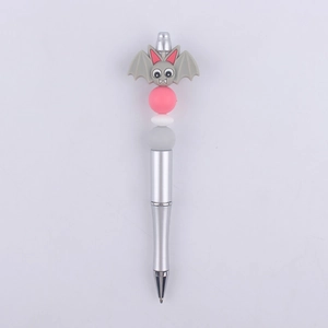 Close-up of a DIY beaded pen featuring a grey silicone bat charm and pastel colored beads
