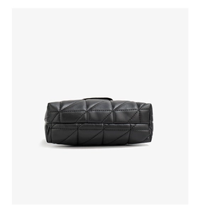 Close-up of black quilted leather texture and detailed stitching on the crossbody bag