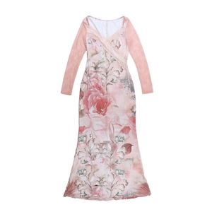 Close-up of pink floral dress featuring lace sleeves and delicate V-neck patchwork detail