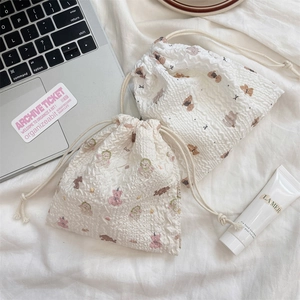 Detail of seersucker drawstring bags with cute bear patterns and soft fabric texture