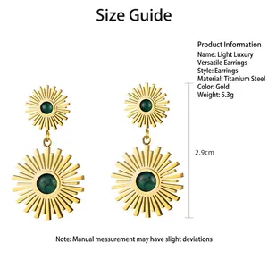 Gold stainless steel starburst earrings with green stone inlay on white background
