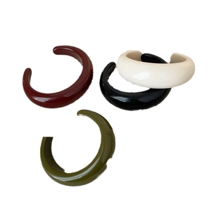 Set of minimalist resin C-shaped ear cuffs in dark red, black, cream, and olive green