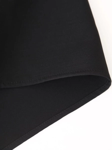 Close-up of black chiffon fabric showing professional stitching and fine texture details