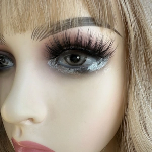 Cat eye faux mink eyelashes on a model with long blonde hair and silver eye shadow