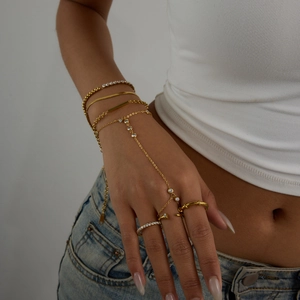 Detail shot of gold-plated finger bracelet with rhinestones and matching ring set