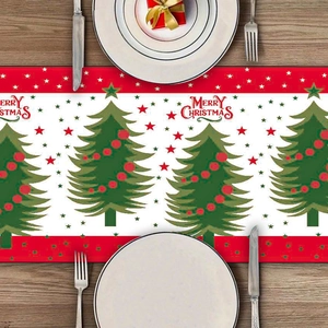 Christmas table runner with green trees and red border on rustic wooden dining table