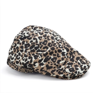Detail of leopard print flat cap featuring vintage bronze metal side buckle adjustment