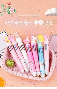 Close-up of cute cartoon silicon toppers on 10-color retractable ballpoint pens in a basket