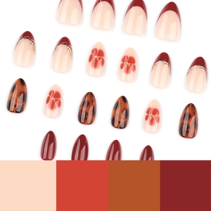 Burgundy and amber tortoiseshell press-on nails with floral French patterns and oval shape