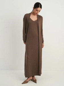 Detail of soft dark brown knit cardigan and maxi dress set showing premium texture