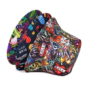Detailed stack of printed bucket hats in black, navy, and tattoo style patterns