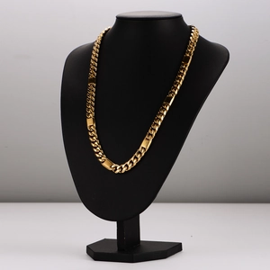 Chunky two-tone stainless steel Cuban link necklace displayed on a black mannequin stand