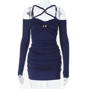 Close-up of navy blue pleated dress featuring criss-cross halter neck and metal ring detail