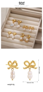 Detail view of 18K gold bow earrings with baroque pearls and precise size measurements
