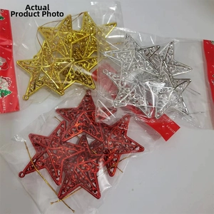 Detail of Christmas hollow star ornaments in gold, silver and red metallic finishes