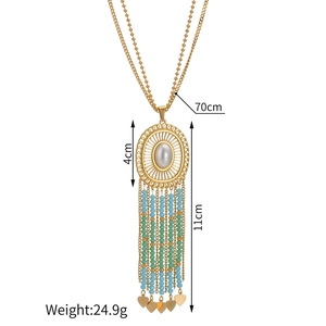 Detail of bohemian gold fringe necklace showing dimensions and white faux pearl pendant