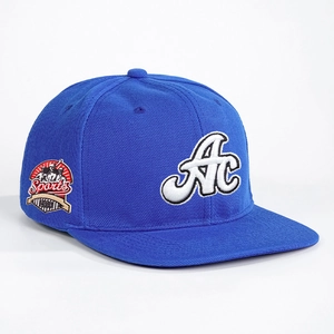 Close-up of bright blue baseball cap featuring 3D AC embroidery and 1993 vintage patch