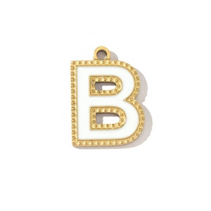 Detail of a gold-plated alphabet B pendant with white enamel inlay and top hanging ring
