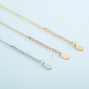Close-up of stainless steel extender chains in gold, rose gold and silver finishes