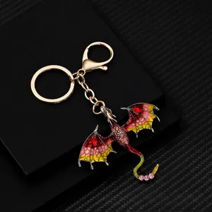 Vintage dragon keychain with colorful enamel and sparkling rhinestones on black background