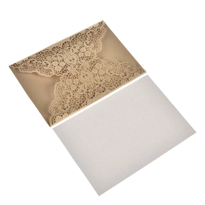 Detailed laser-cut champagne gold lace invitation cover with blank white inner card