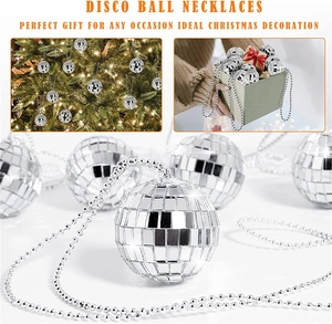 Close-up of shiny disco ball necklace with silver mirror tiles and gift box packaging