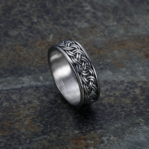 Detailed macro view of retro stainless steel ring with Celtic weave pattern on stone base