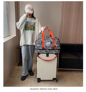 Vue détaillée du sac de sport zébré avec poignées orange vif et compartiment à chaussures