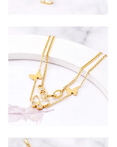 Detail of 18k gold layered butterfly bracelet with shell inlay on white marble