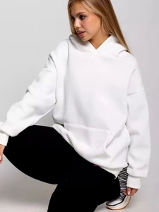 Detail of white oversized hoodie featuring a large kangaroo pocket and dropped shoulders