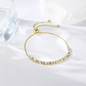 Close-up of gold adjustable bolo bracelet with sparkling marquise cut cubic zirconia