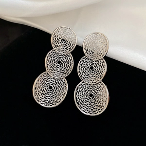 Detail of silver drop earrings with geometric hollow mesh and layered circles