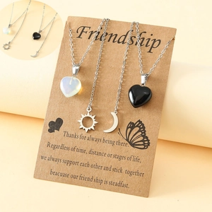 Friendship necklace set with sun, moon, and heart pendants on kraft gift cards