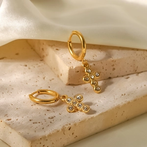 Detail of 18K gold-plated titanium steel hoop earrings with crystal cross pendants