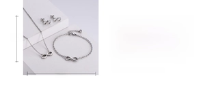 Polished silver infinity jewelry set with dimensions shown on a stone background