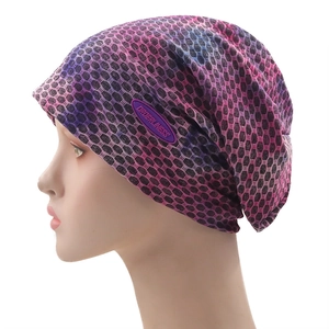 Close-up of honeycomb mesh texture and logo label on the tricolor knitted beanie