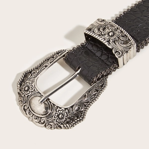 Vintage black crocodile embossed belt featuring a large ornate silver floral buckle