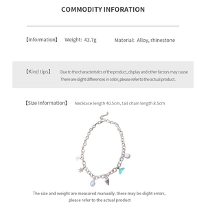 Macro detail of alloy fishtail and seashell necklace charms with rhinestone inlays