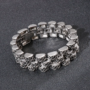 Macro detail of silver stainless steel thick link bracelet with Celtic woven texture