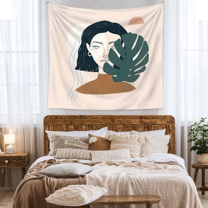 Detail of bohemian tapestry featuring abstract female face and green leaf in warm bedroom
