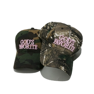 Detail view of pink 3D embroidered lettering on vintage camouflage baseball caps
