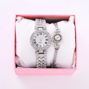 Silver iced-out quartz watch and bracelet set displayed in a premium pink gift box