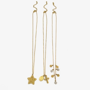 Three gold layered stainless steel necklaces with cross, star, and virgin mary pendants