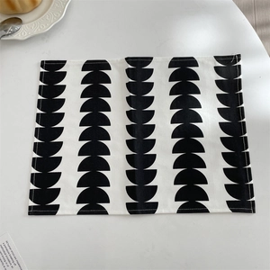 Close-up of geometric black semi-circle pattern on a minimalist fabric placemat