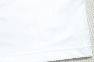 Close-up of high-quality white knitted fabric showing precise stitching and soft texture
